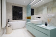 Elegant bathroom with bathtub and blue furniture