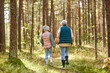 © Syda Productions - mushroom picking season, leisure and people concept - grandmother and granddaughter with baskets walking in forest