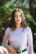 © ADDICTIVE STOCK - Tender teen girl with flowers in jeans looking at camera