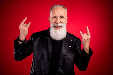 Poster - Portrait of attractive cheerful cool grey-haired man showing horn sign having fun isolated over bright red color background