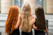 © Maria Moroz - In summer, three teenage girls with loose long hair, a blonde, a redhead and a brunette, stand on their backs.