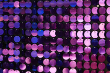 Shiny Texture Of The Background, A Set Of Round Purple Sequins Sewn On The Fabric Like Fish Scales
