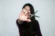 © AliciaFdez - Beautiful brunette woman with long hair showing the scissors to the camera.