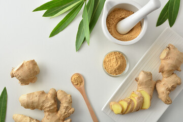 Poster - Ginger powder and ginger root on white table top view