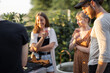 © rh2010 - Young friends having fun at picnic outdoors, talk and drink wine at the backyard on a sunset. Spending summer time in a small group on the open air