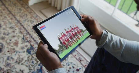 Sticker - Composite of man sitting at home, watching sports event on tablet