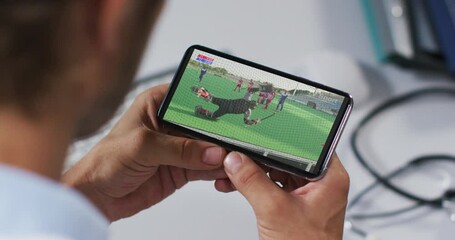 Wall Mural - Composite of male doctor watching hockey match on smartphone