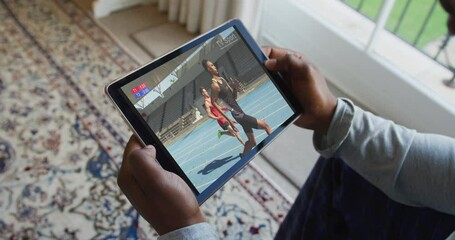 Poster - Composite of man sitting at home watching athletics running event on tablet