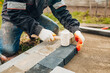Fitting and tamping paving stones with a rubber mallet - installation of paving slabs