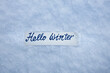 © Leka - marker inscription hello winter on  a of white fluffy snow  background, snow texture background