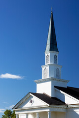 Wall Mural - Closeup of white church steeple with blue sky