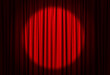 © New Africa - Spotlight illuminating closed red stage curtains. Start of performance
