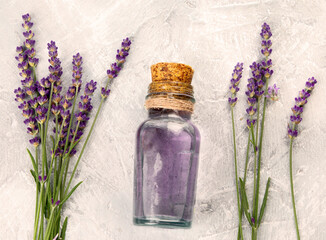 Sticker - Bottle of essential oil and lavender flowers on light gray background.