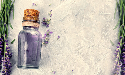 Sticker - Bottle of essential oil and lavender flowers on light gray background.