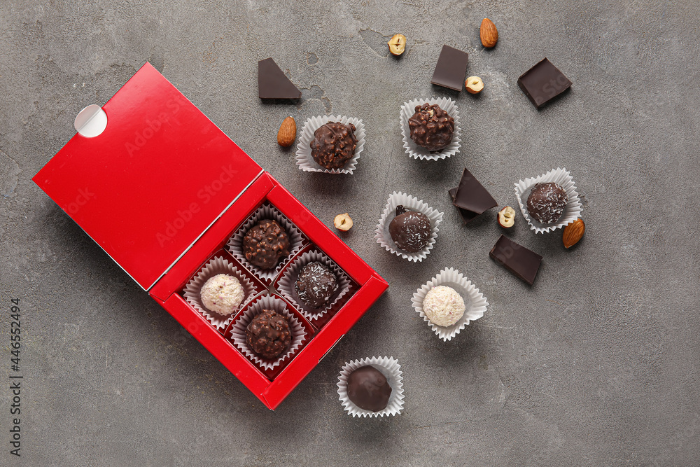 Box with sweet chocolate candies on grunge background