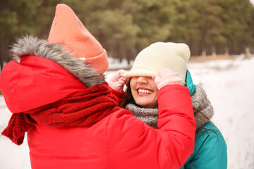 Canvas Print - Happy mother and her little daughter in park on winter day