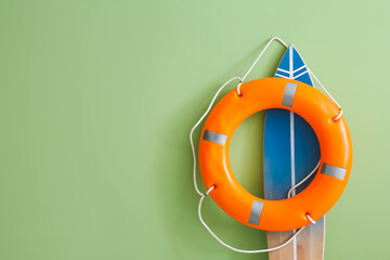 Wall Mural - Surfboard and lifebuoy on color background