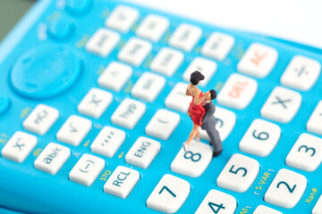 The cost of marriage creative miniature figures on the calculator