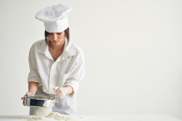 Wall Mural - woman baker sift flour working with dough Professional