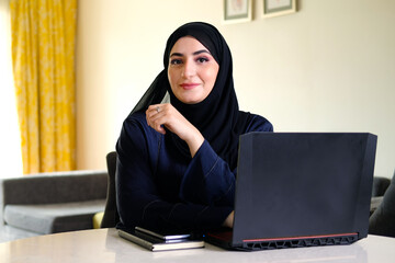 Arab Emirati Algerian business woman. Authentic Arabic lady not Indian wearing Abaya Hijab ideal for corporate, marketing or bank financial concept. 