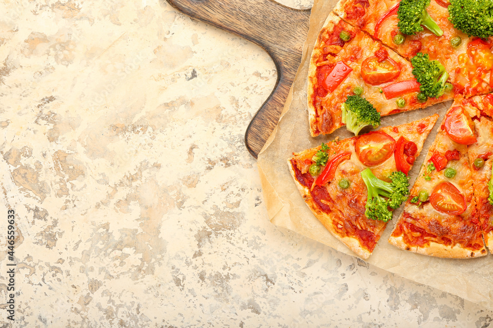 Board with tasty vegetarian pizza on light background