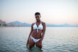 © ADDICTIVE STOCK - Black woman with short hair in the sea