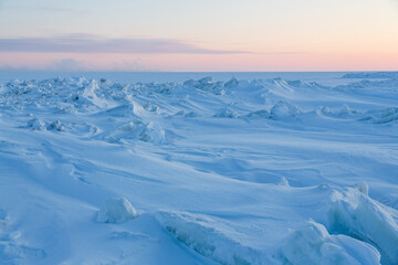 Wall Mural - winter arctic landscape. view of snow and ice at sunset. ice hummocks on the frozen sea in the arcti