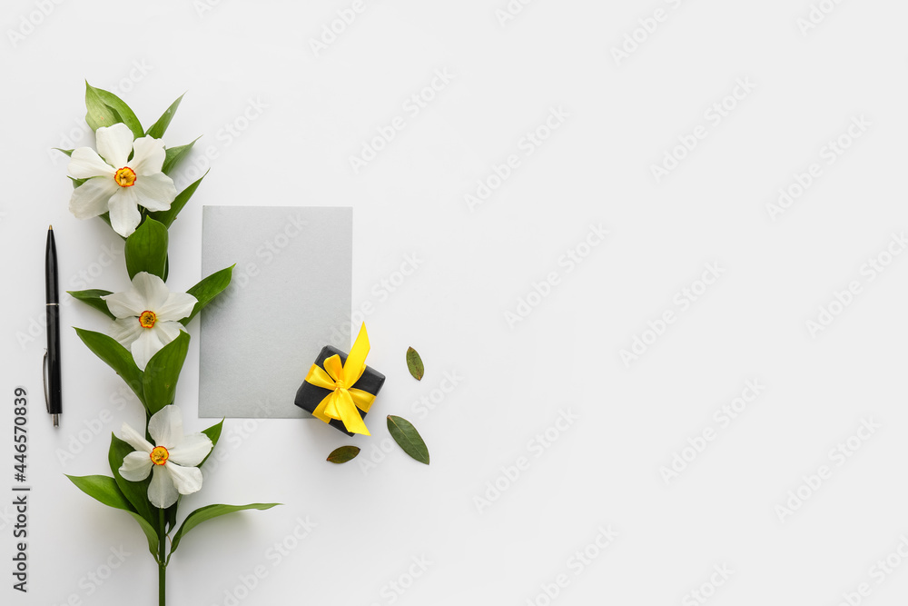 Beautiful daffodils, gift box and blank card on white background - obrazy, fototapety, plakaty 