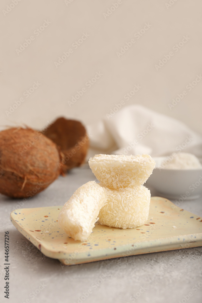 Plate with tasty coconut mochi on grunge background