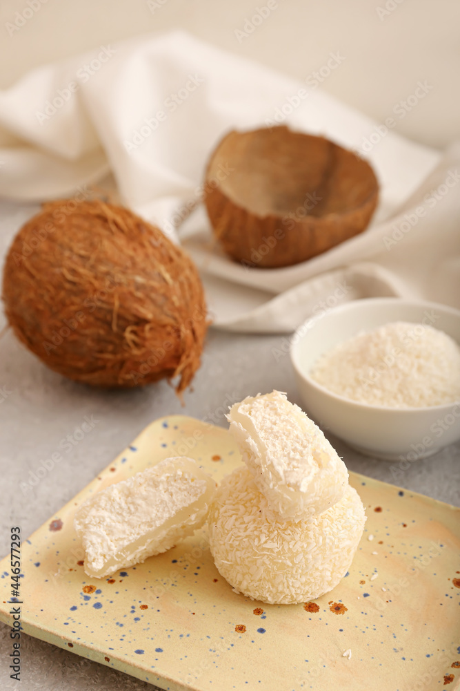 Plate with tasty coconut mochi on grunge background