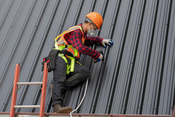 Sticker - Construction worker installing metal sheet roof at the construction site