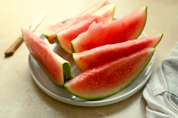 Wall Mural - Summer foods background. Ripe watermelon slices in a plate, on warm background