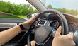 © Viktoriia - A man driving a car passing by a beautiful forest landscape. Car rental
