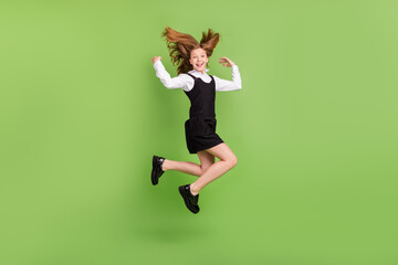 Poster - Full length body size view of attractive cheerful girl jumping having fun good mood isolated over green color background