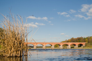 Wall Mural - Long brick bridge in sunny autumn day, Kuldiga, Latvia.