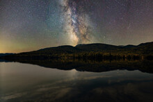 Starry Night Sky. The Milky Way Is Reflected In The Lake. The Mountains Are Sleeping Peacefully. 