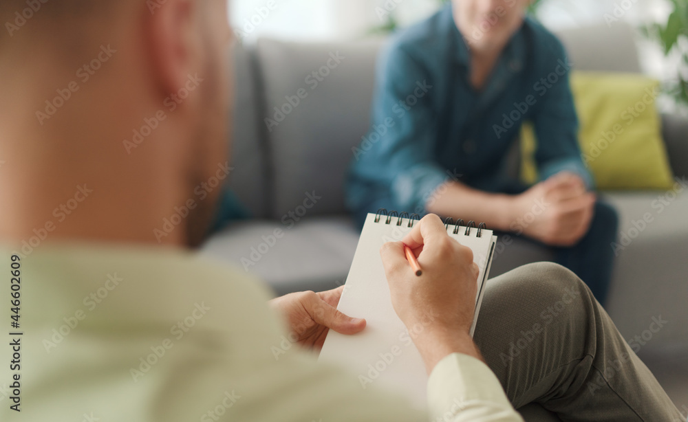 Professional therapist meeting a patient in his office - obrazy, fototapety, plakaty 