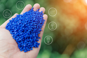 Hand holding plastic beads. recycle icon. Save environment concept. blue polymer pallet.