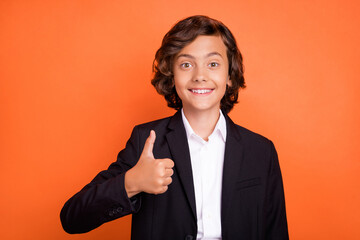 Sticker - Photo of young happy cheerful attractive boy make thumb up good mood like isolated on orange color background