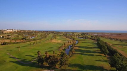 Wall Mural - Green golf courses by the sea. Salgados beach. Portugal, Albufeira. Aerial view.