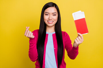 Poster - Photo of sweet brunette hair millennial lady hold passport show heart wear pink sweater isolated on yellow color background