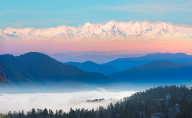 Wall Mural - Amazing blue mountains over the white clouds with gorgeous blue sky in the background