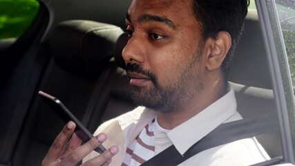 Sticker - transport, business and technology concept - happy smiling indian male passenger or businessman using voice command recorder on smartphone on back seat of taxi car