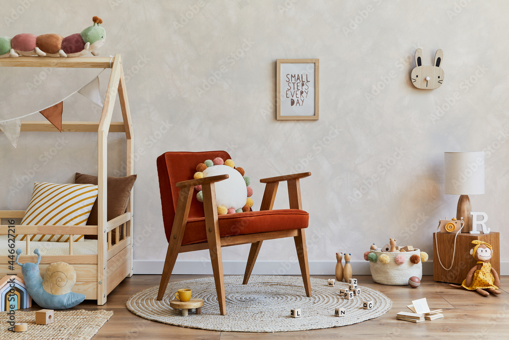 Stylish composition of cozy scandinavian child's room interior with wooden bed, red armchair, plush and wooden toys and textile decorations. Creative wall, carpet on the floor. Copy space. Template. - obrazy, fototapety, plakaty 