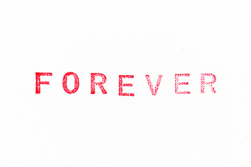 red color rubber stamp in word forever on white paper background
