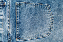 Close Up On A Back Pocket Of A Blue Jeans. Fabric And Stitching Details Of The Back Pocket Of A Pair Of Jeans.