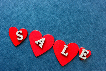 Wall Mural - sale sign with red hearts on a blue background