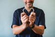 Male doctor holding two heart shaped transparent dental aligners
