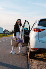 Sticker - woman with basket of flowers sitting in car