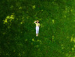 overhead view of woman laying down on green grass